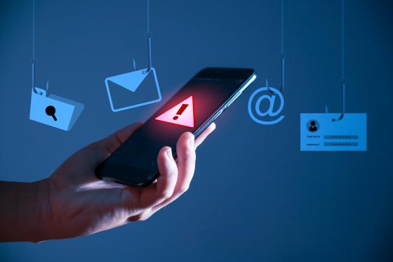 Warning screen on phone with email icons floating around