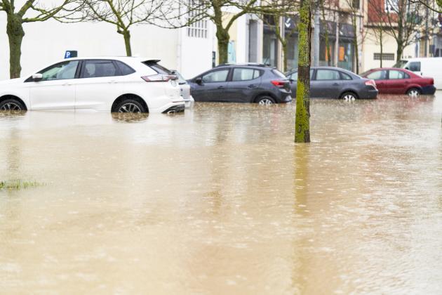 Vehicles parked on a flooded street